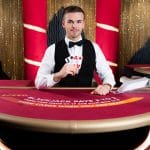 Blackjack live dealer holding cards