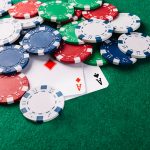 Poker cars and chips on green gambling table