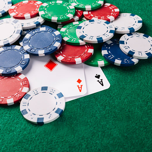 Poker cars and chips on green gambling table