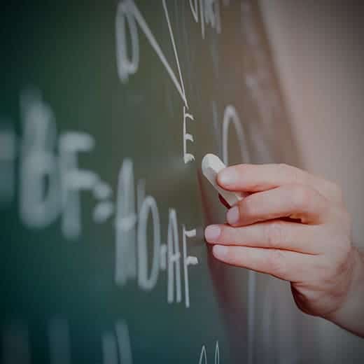 Teacher writing down math formula