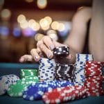 Women hand taking four chips from the stack