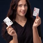 Nice-looking girl holding aces