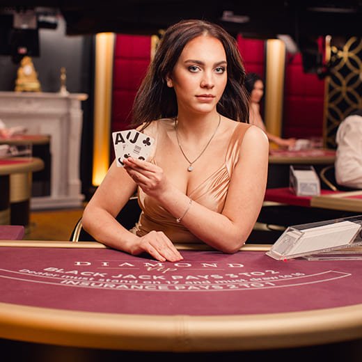 Blackjack dealer holding cards