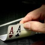 Poker player holding two aces